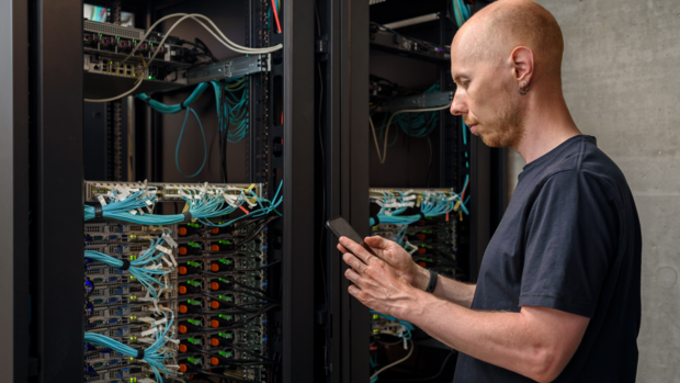 Technician documenting IT inventory in a data center rack, demonstrating DC Smarter's inventory as a service solution for efficient and accurate asset management without the need for additional hardware.