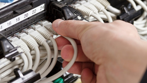 Technician using augmented reality to view digital twin for accurate cable installation.